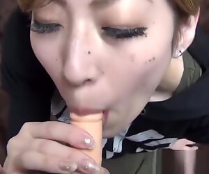 Skinny Japanese babe rides and sucks a small dildo in POV